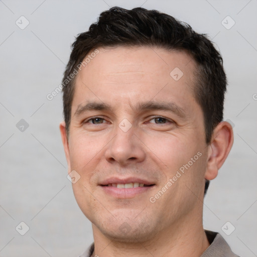 Joyful white young-adult male with short  brown hair and brown eyes