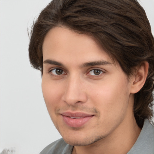 Joyful white young-adult male with medium  brown hair and brown eyes