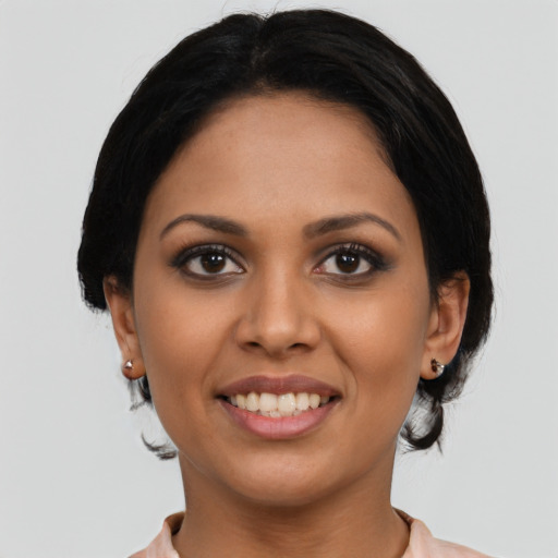 Joyful latino young-adult female with medium  black hair and brown eyes