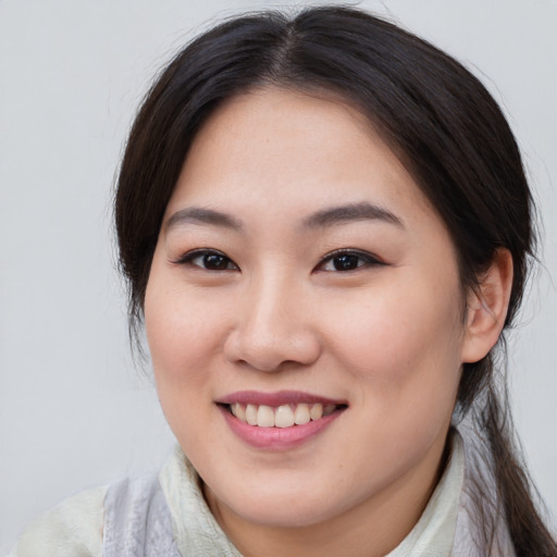 Joyful asian young-adult female with medium  brown hair and brown eyes