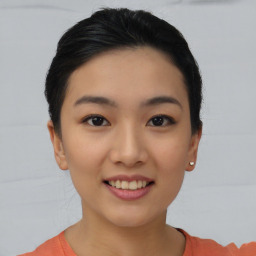 Joyful asian young-adult female with short  black hair and brown eyes