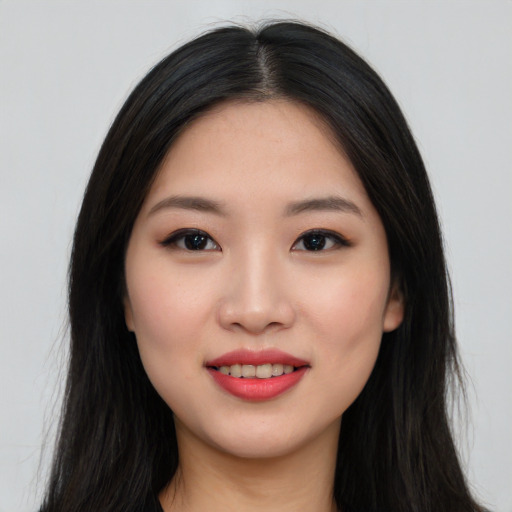 Joyful asian young-adult female with long  black hair and brown eyes