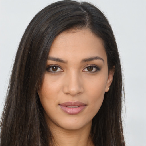 Joyful latino young-adult female with long  brown hair and brown eyes