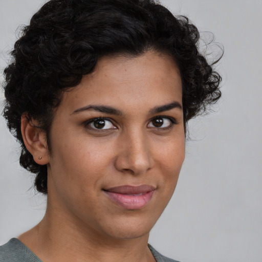 Joyful latino young-adult female with short  brown hair and brown eyes