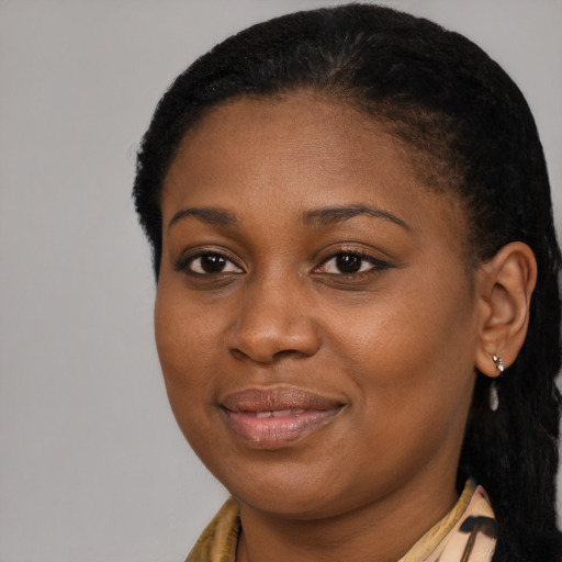Joyful black young-adult female with short  brown hair and brown eyes