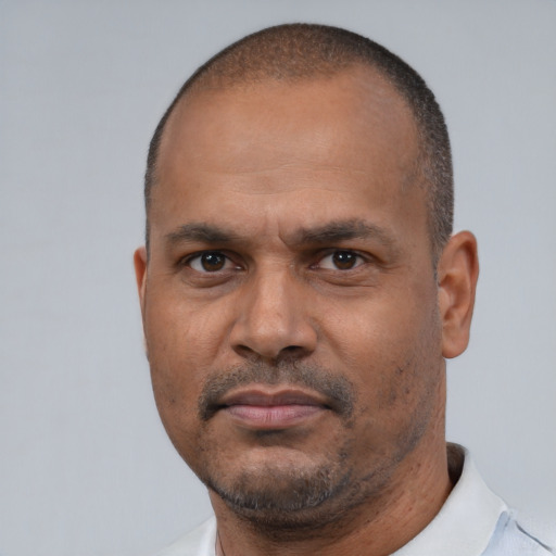 Neutral latino adult male with short  black hair and brown eyes