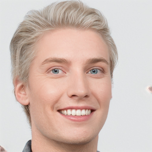 Joyful white young-adult male with short  brown hair and blue eyes