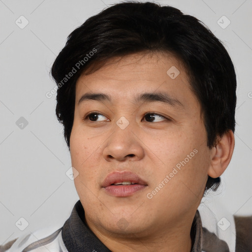 Joyful asian young-adult male with short  black hair and brown eyes
