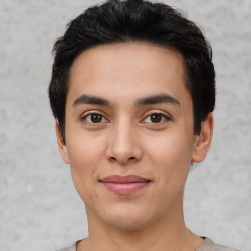 Joyful white young-adult male with short  black hair and brown eyes