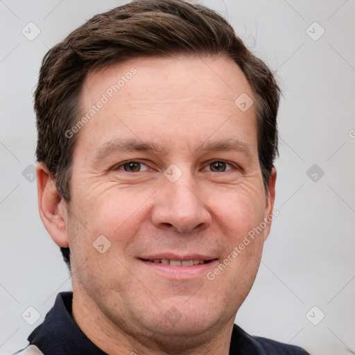 Joyful white adult male with short  brown hair and grey eyes