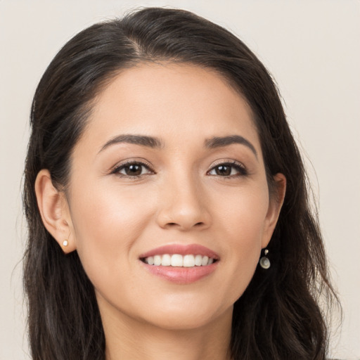 Joyful white young-adult female with long  brown hair and brown eyes