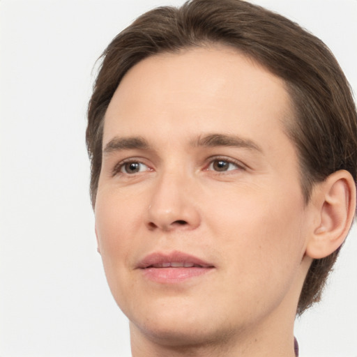 Joyful white young-adult male with medium  brown hair and brown eyes