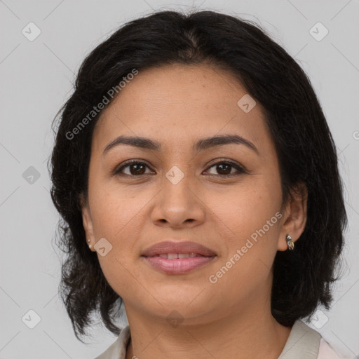 Joyful latino young-adult female with medium  brown hair and brown eyes