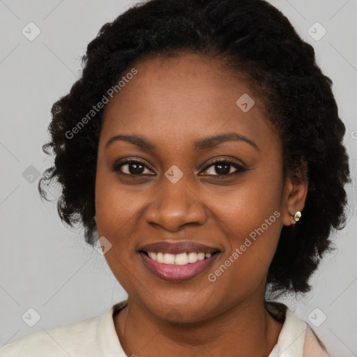 Joyful black young-adult female with long  brown hair and brown eyes