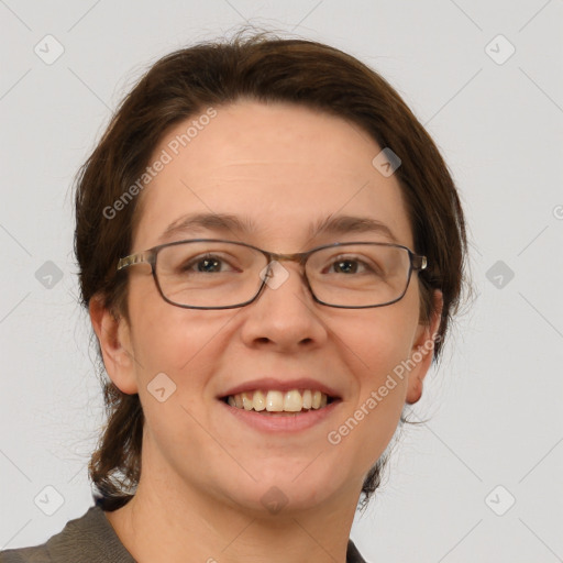 Joyful white adult female with medium  brown hair and grey eyes