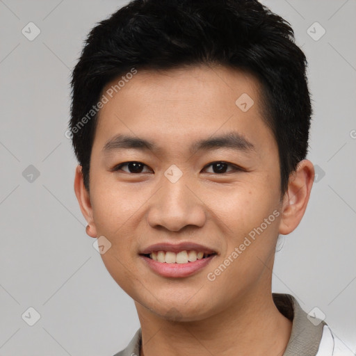 Joyful asian young-adult male with short  black hair and brown eyes