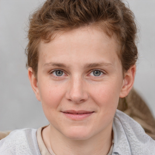 Joyful white young-adult male with short  brown hair and blue eyes