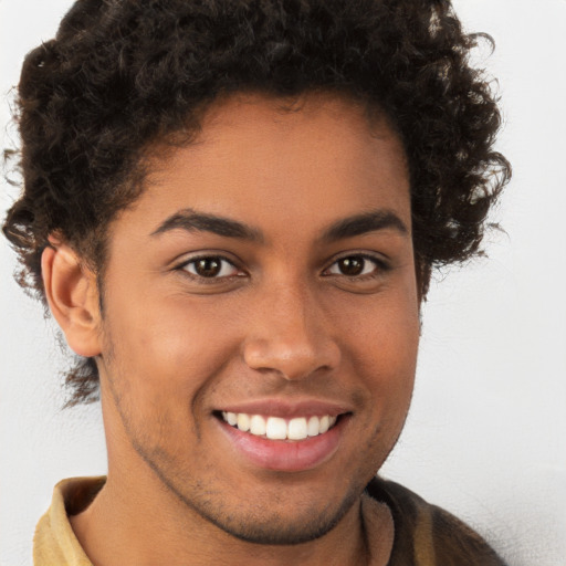 Joyful latino young-adult male with short  brown hair and brown eyes