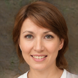 Joyful white adult female with medium  brown hair and brown eyes