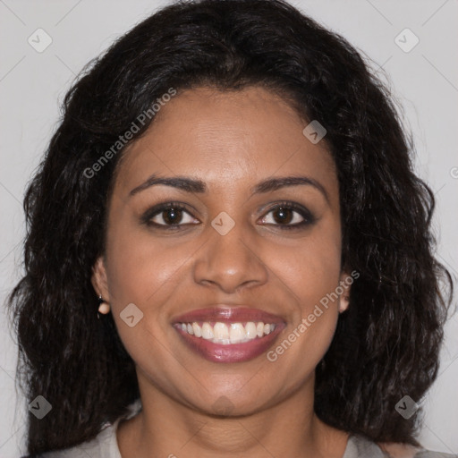 Joyful black young-adult female with long  brown hair and brown eyes