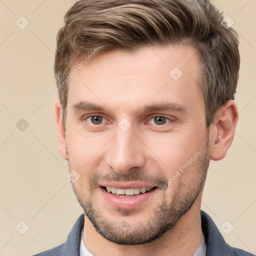 Joyful white young-adult male with short  brown hair and brown eyes