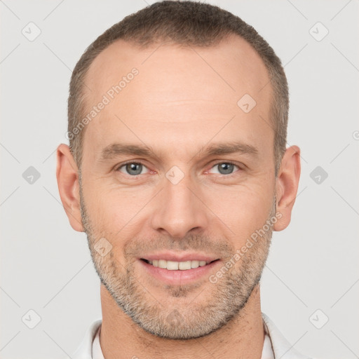 Joyful white adult male with short  brown hair and brown eyes