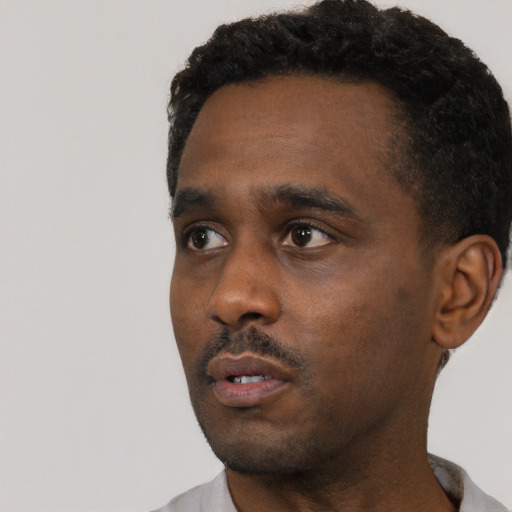 Neutral black young-adult male with short  black hair and brown eyes