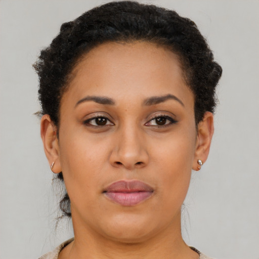 Joyful latino young-adult female with short  brown hair and brown eyes