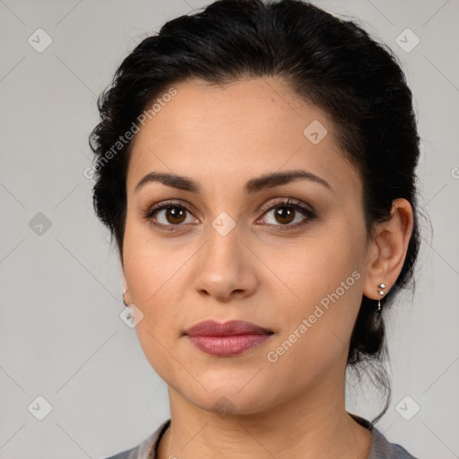 Joyful latino young-adult female with medium  brown hair and brown eyes