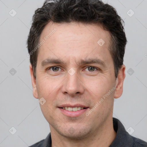 Joyful white adult male with short  brown hair and brown eyes