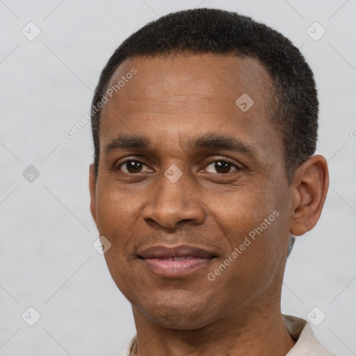 Joyful latino adult male with short  brown hair and brown eyes
