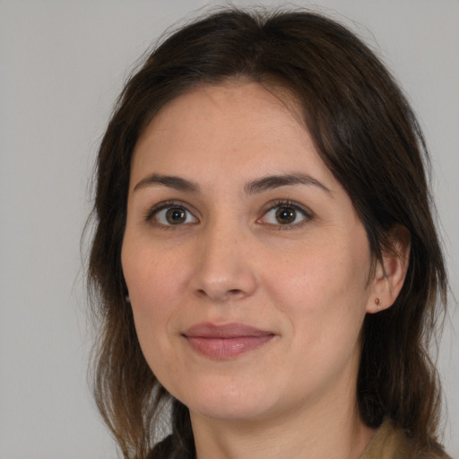 Joyful white young-adult female with medium  brown hair and brown eyes