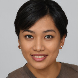 Joyful asian young-adult female with short  black hair and brown eyes