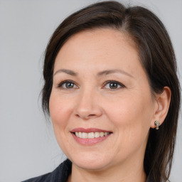 Joyful white adult female with medium  brown hair and brown eyes