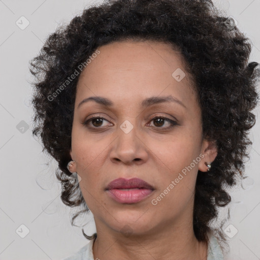 Joyful black adult female with medium  brown hair and brown eyes