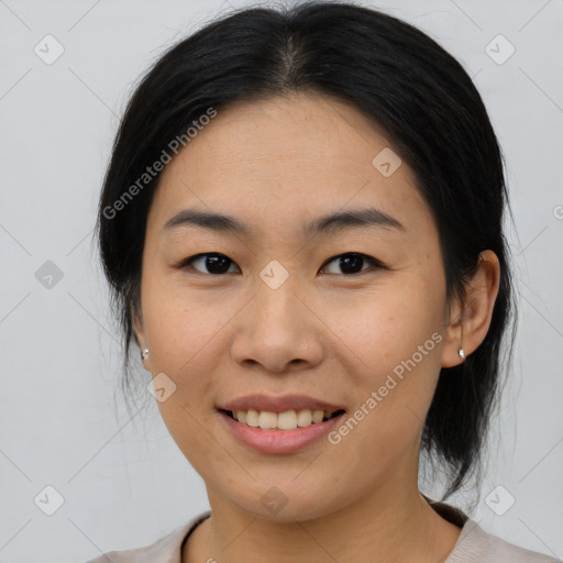 Joyful asian young-adult female with medium  brown hair and brown eyes