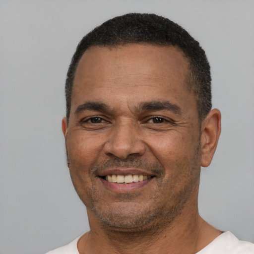 Joyful white adult male with short  black hair and brown eyes