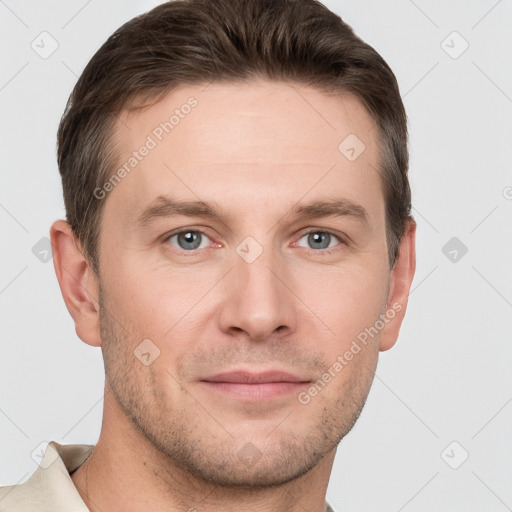 Joyful white young-adult male with short  brown hair and grey eyes