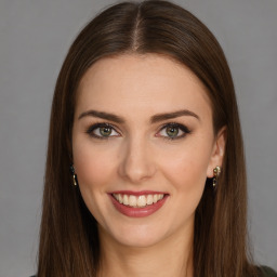 Joyful white young-adult female with long  brown hair and green eyes