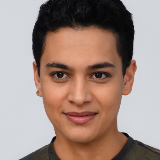 Joyful latino young-adult male with short  black hair and brown eyes