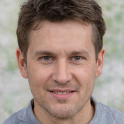 Joyful white adult male with short  brown hair and brown eyes