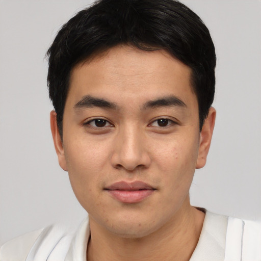 Joyful asian young-adult male with short  black hair and brown eyes