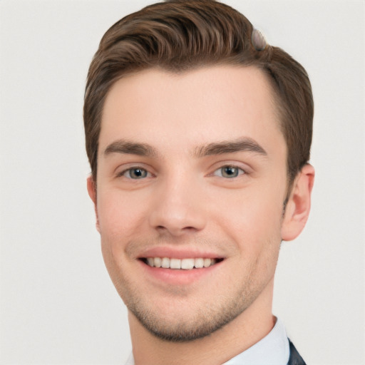 Joyful white young-adult male with short  brown hair and grey eyes