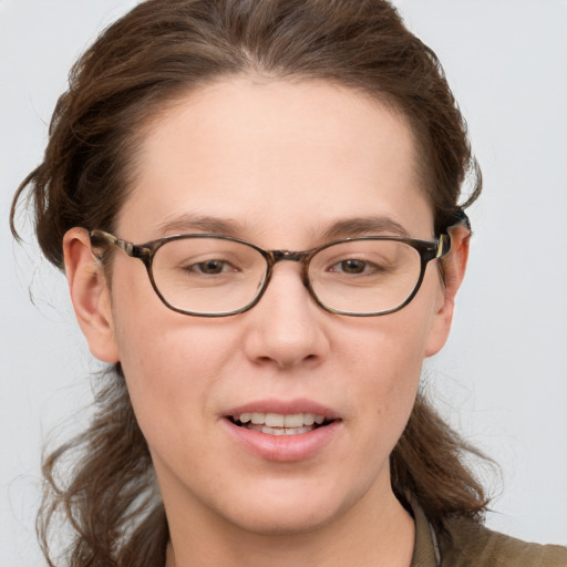 Joyful white young-adult female with medium  brown hair and blue eyes