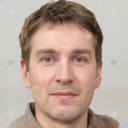 Joyful white adult male with short  brown hair and grey eyes