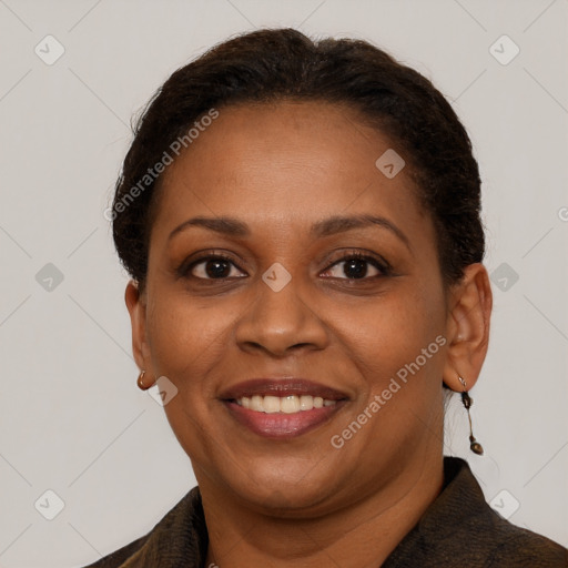 Joyful black adult female with short  brown hair and brown eyes