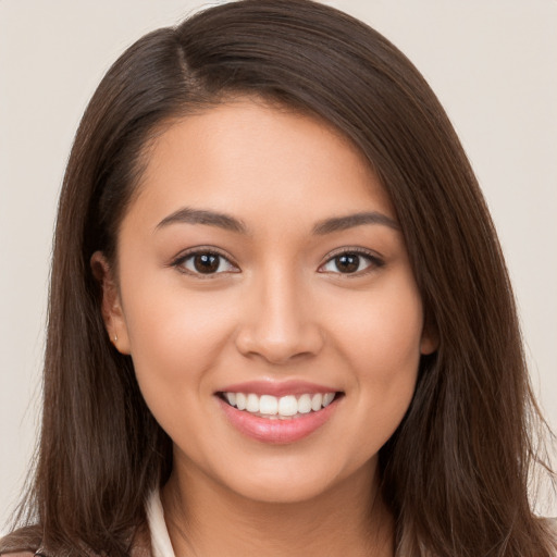 Joyful white young-adult female with long  brown hair and brown eyes