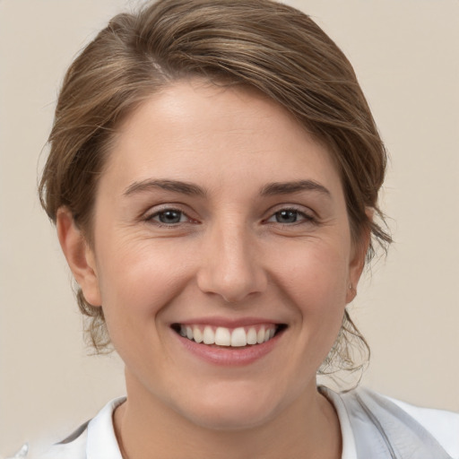 Joyful white young-adult female with medium  brown hair and brown eyes