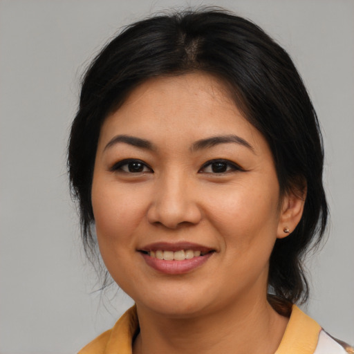 Joyful asian young-adult female with medium  brown hair and brown eyes