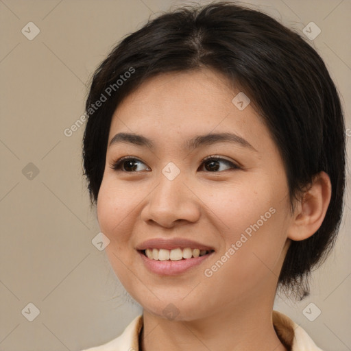 Joyful asian young-adult female with medium  brown hair and brown eyes